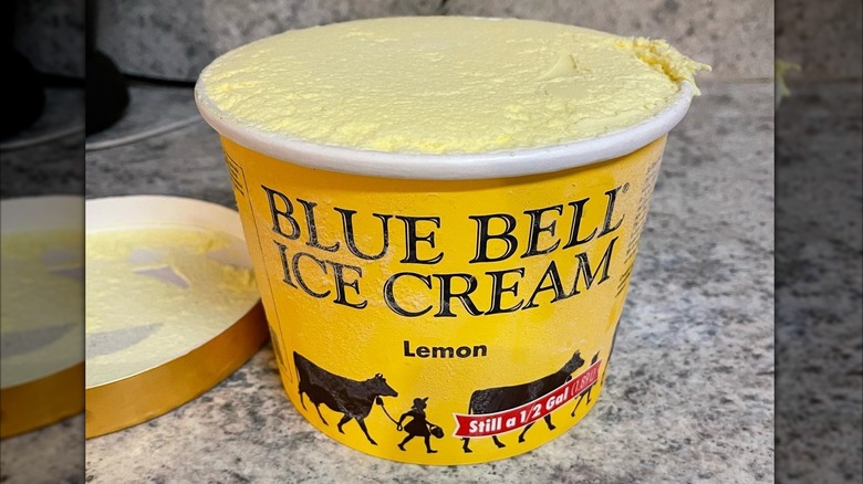 An open carton of Blue Bell Lemon ice cream on a kitchen counter