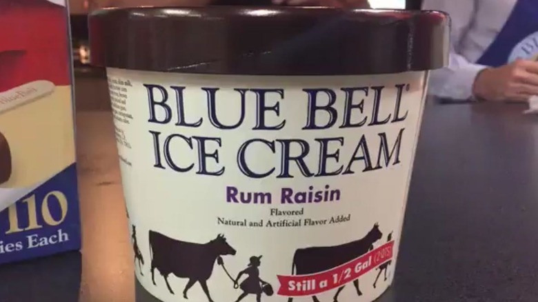 A carton of Blue Bell Rum Raisin ice cream on a countertop