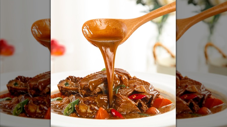 dish of pot roast with a spoonful of gravy getting poured over it