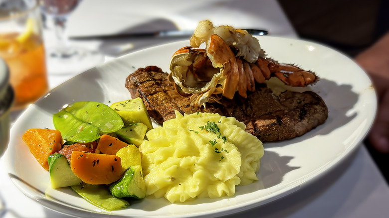 Steak and lobster dinner with mashed potatoes