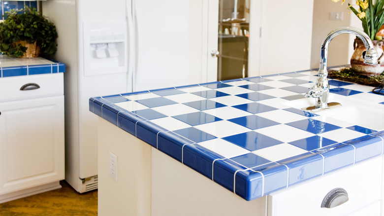 Kitchen island with blue and white tiles