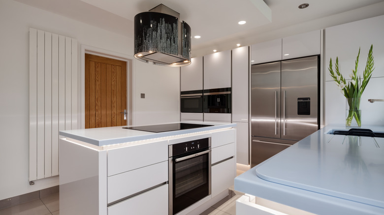 Modern kitchen with blue and white solid surface Corian countertops
