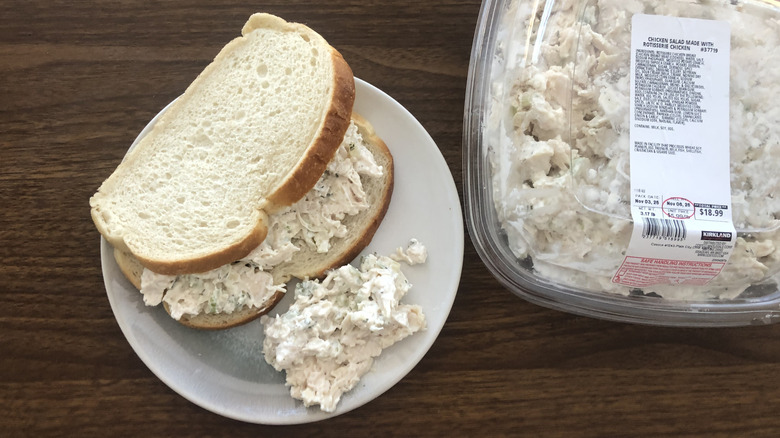 Costco rotisserie chicken salad on a plate and in between sourdough bread.