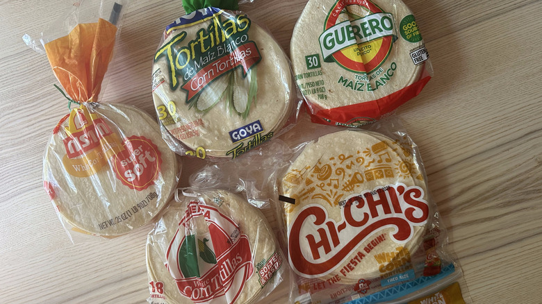 Bags of corn tortillas on wooden table