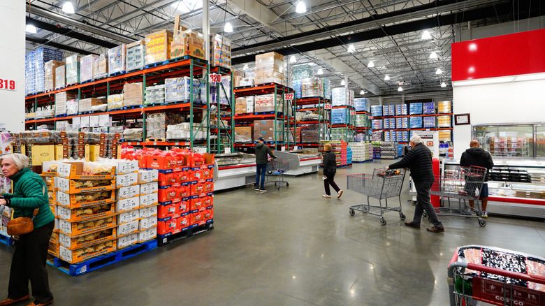 Shoppers pushing carts in Costco store