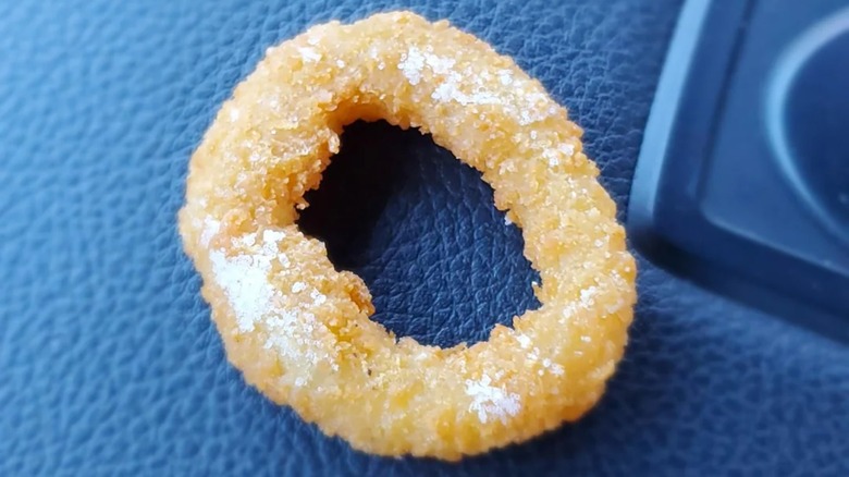 A Burger King onion ring with salt on top.