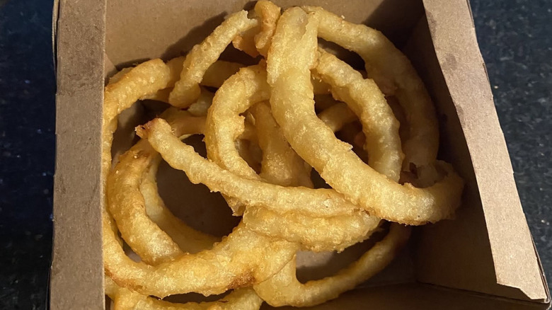 A cardboard container filled with onion rings from Burger King Canada