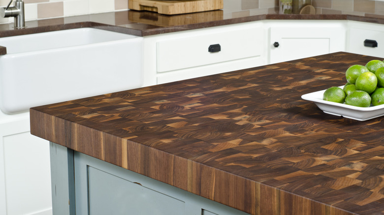 A close-up view of a high-end butcher block countertop in a dark wood checkerboard pattern