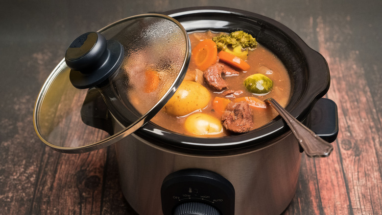 A beef stew being cooked in a small slow cooker