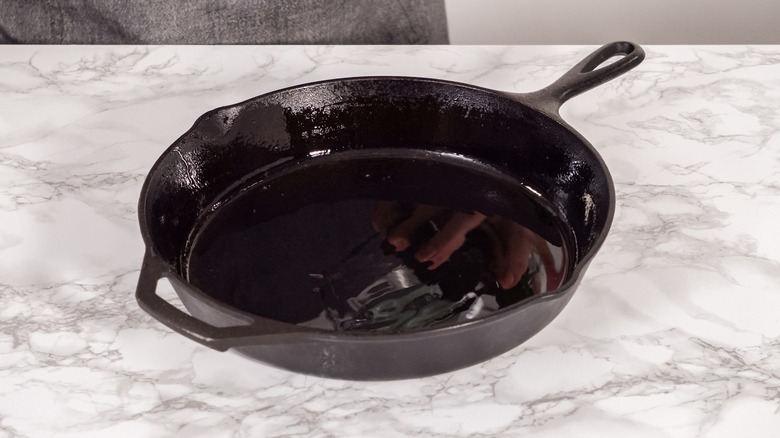 Cast-iron skillet resting on a light marble-look countertop
