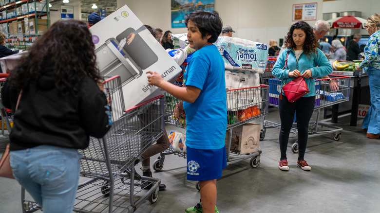 Overloaded Costco cart at checkout