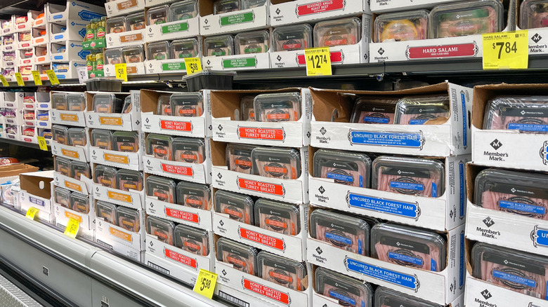 A grocery store aisle containing various deli meats