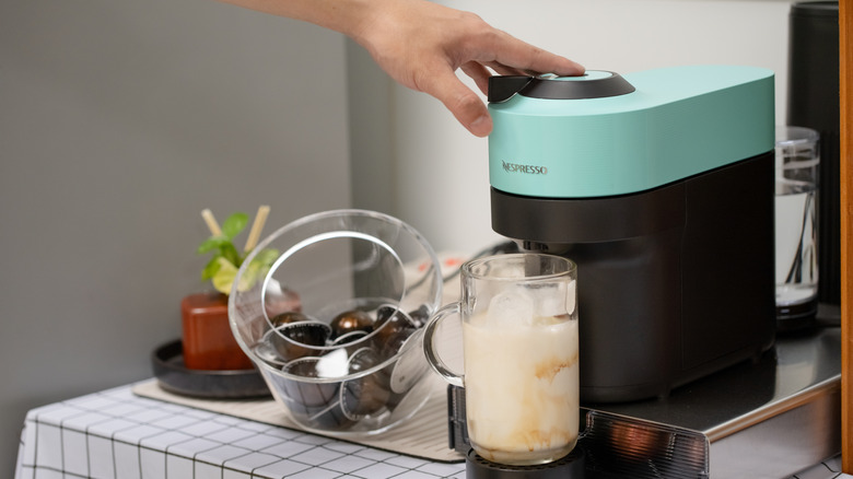 Pushing button on Nespresso machine