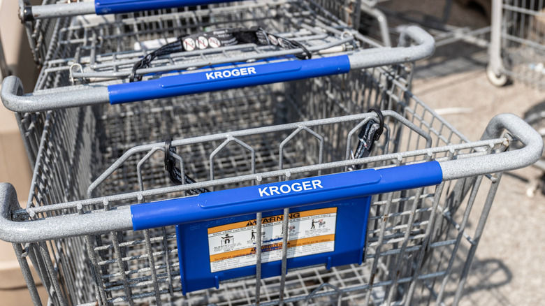A closeup of Kroger shopping carts pushed together