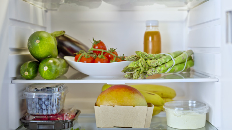 An open fridge full of fruits and veggies