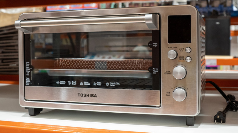 A Toshiba toaster oven-style air fryer with a window door