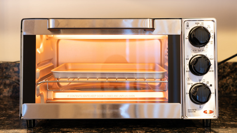 Stainless steel toaster oven sitting on kitchen counter