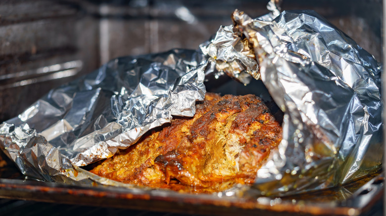 Foil wrapped meat in oven