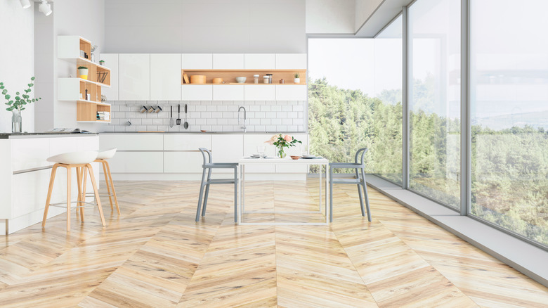 Vinyl floors in a modern kitchen overlooking trees.