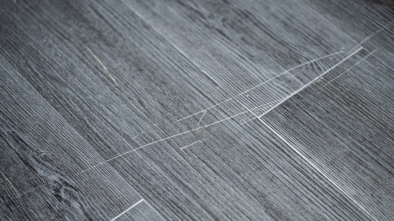 Scratching on a vinyl laminate floor.