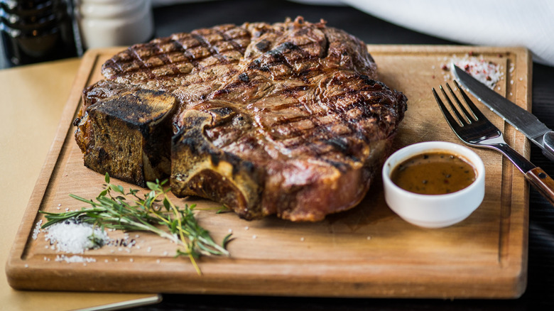 Wooden cutting board with steak
