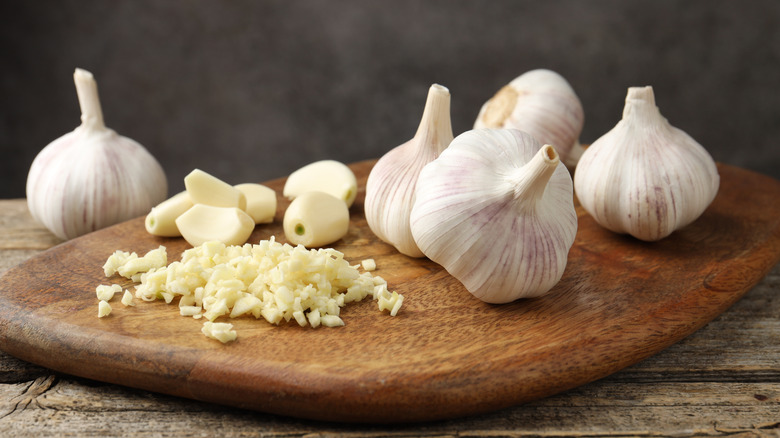 Chopped garlic on wooden cutting board