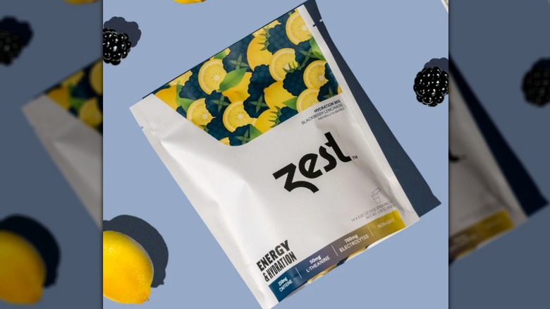 A pouch of Zest Energy powder on a blue background.