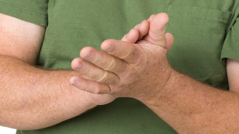 A man's hands rubbing together