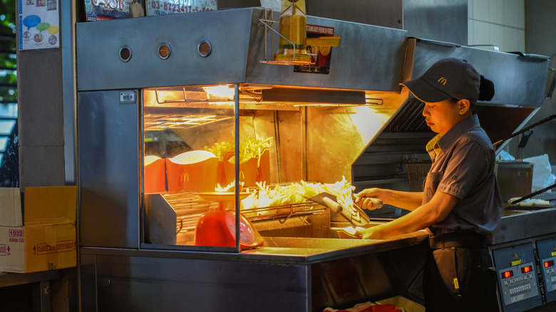 McDonald's employee preparing fries