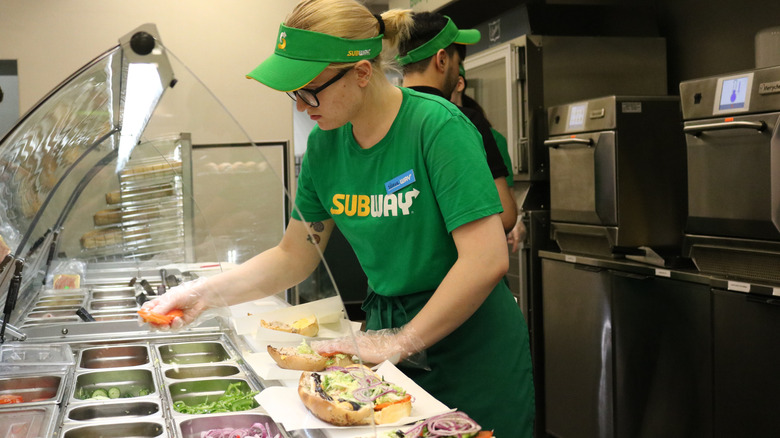 Several Subway sandwiches on a counter