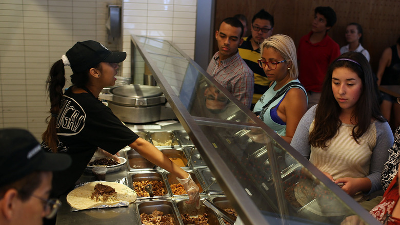 Chipotle workers serving customers