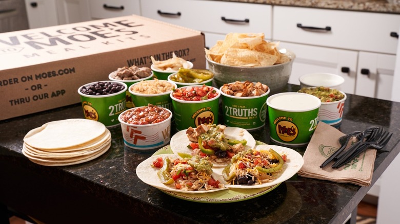 Catered food from Moe's Southwest Grill on a kitchen counter