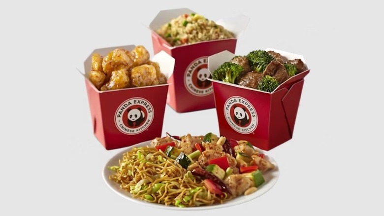a plate of Chinese food in front of cartons of Panda Express food, against a light background