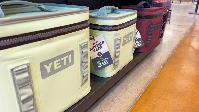 A row of Yeti coolers sitting on a store shelf