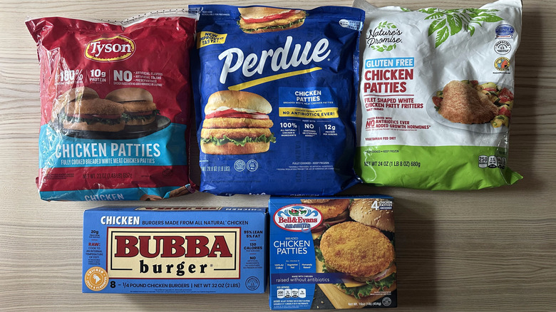 Packages of frozen chicken patties on wooden table