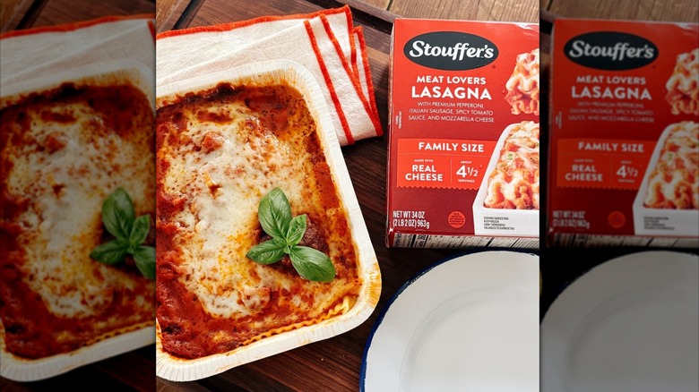 An family-size box of Stouffer's Meat Lovers Lasagna on a counter next to the cooked lasagna