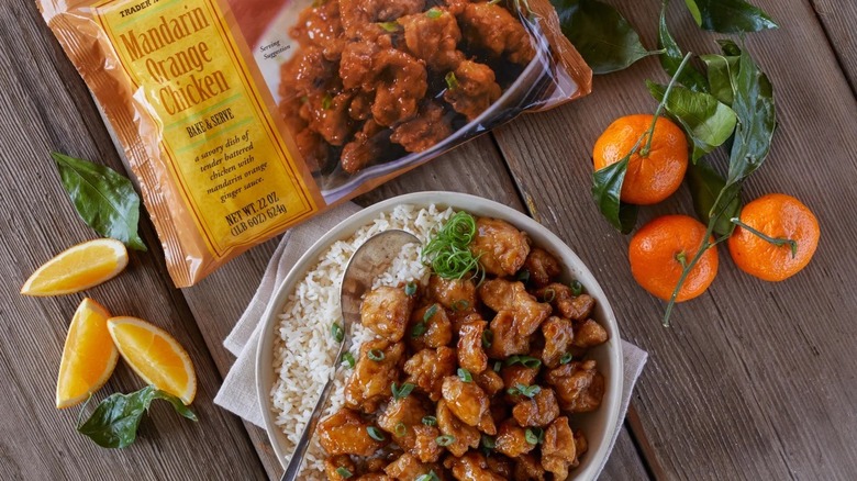A package of Trader Joe's frozen Mandarin Orange Chicken and a bowl of it served with rice