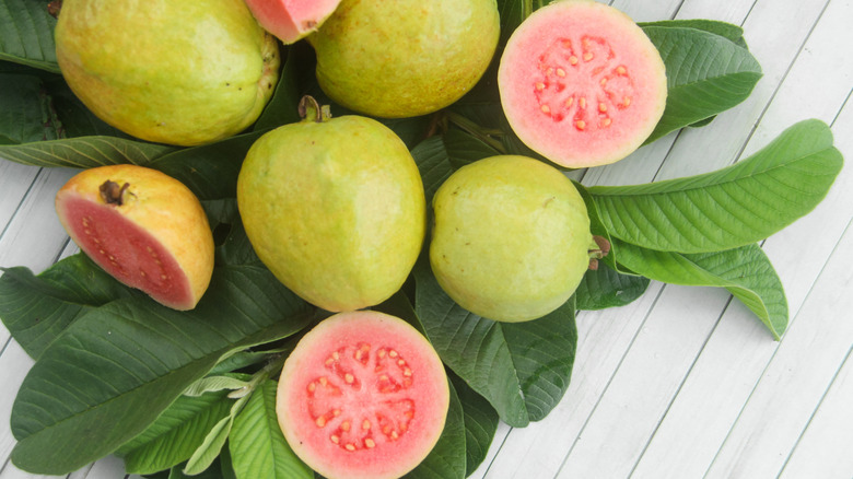 Fresh pink guavas, whole and cut