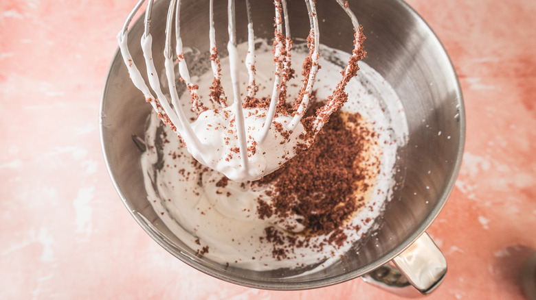 Whipped egg whites in stand mixer with ground freeze-dried raspberries