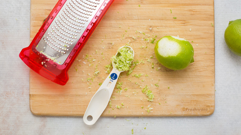 grated lime zest on board