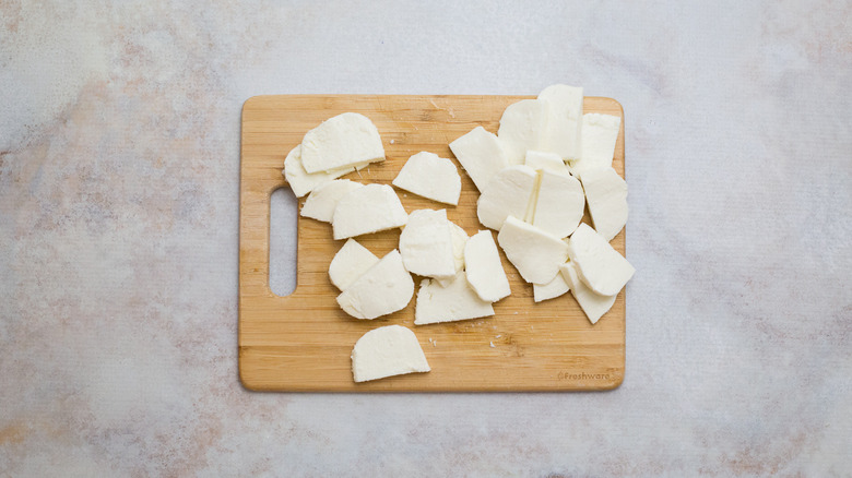 sliced mozzarella on cutting board