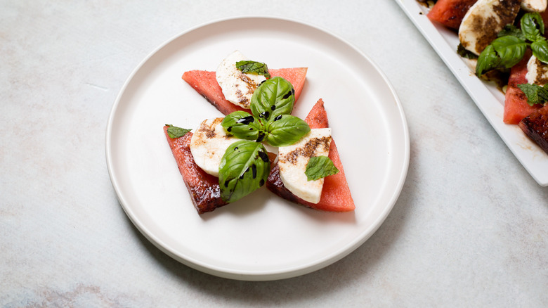 watermelon caprese salad on white plate