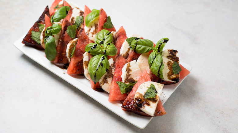 watermelon caprese salad on white plate