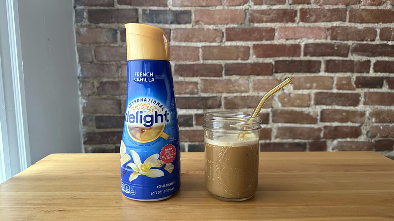 French Vanilla International Delight container next to an iced coffee