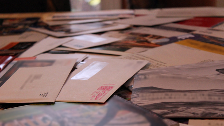 Table covered with junk mail and letters