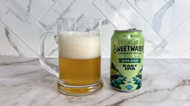 Can of Sweetwater high light IPA and beer in mug