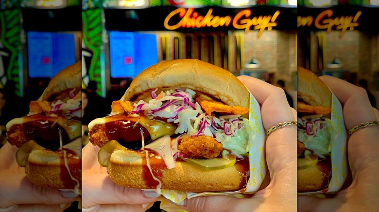 Hands holding Bourbon Brown Sugar BBQ sandwich at Chicken Guy!