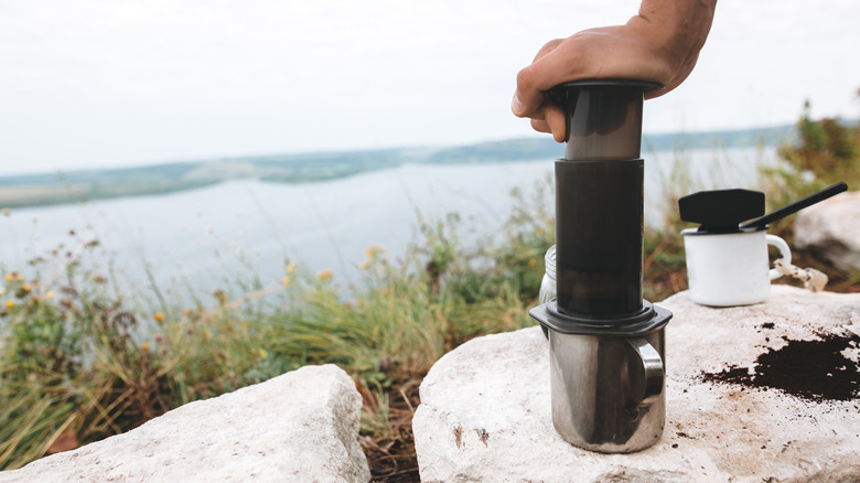 using AeroPress on metal mug in outdoor setting