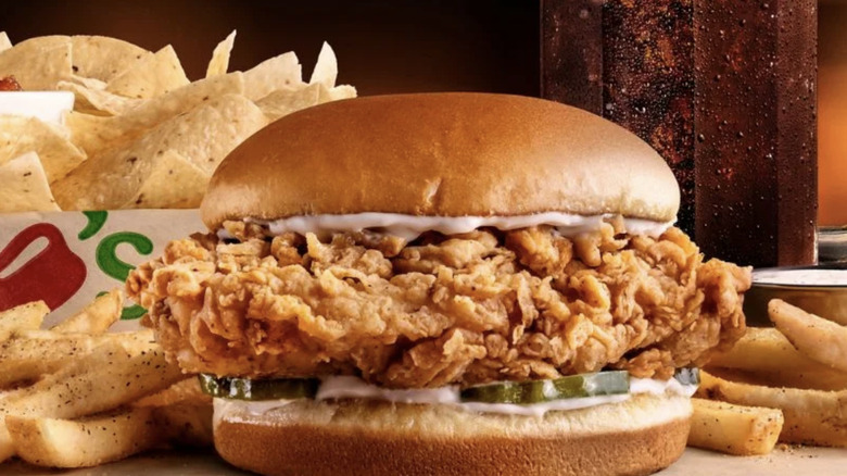A Chili's chicken sandwich, fries, and chips