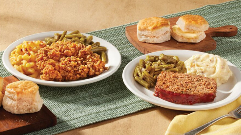 Two Cracker Barrel meals with biscuits on a table
